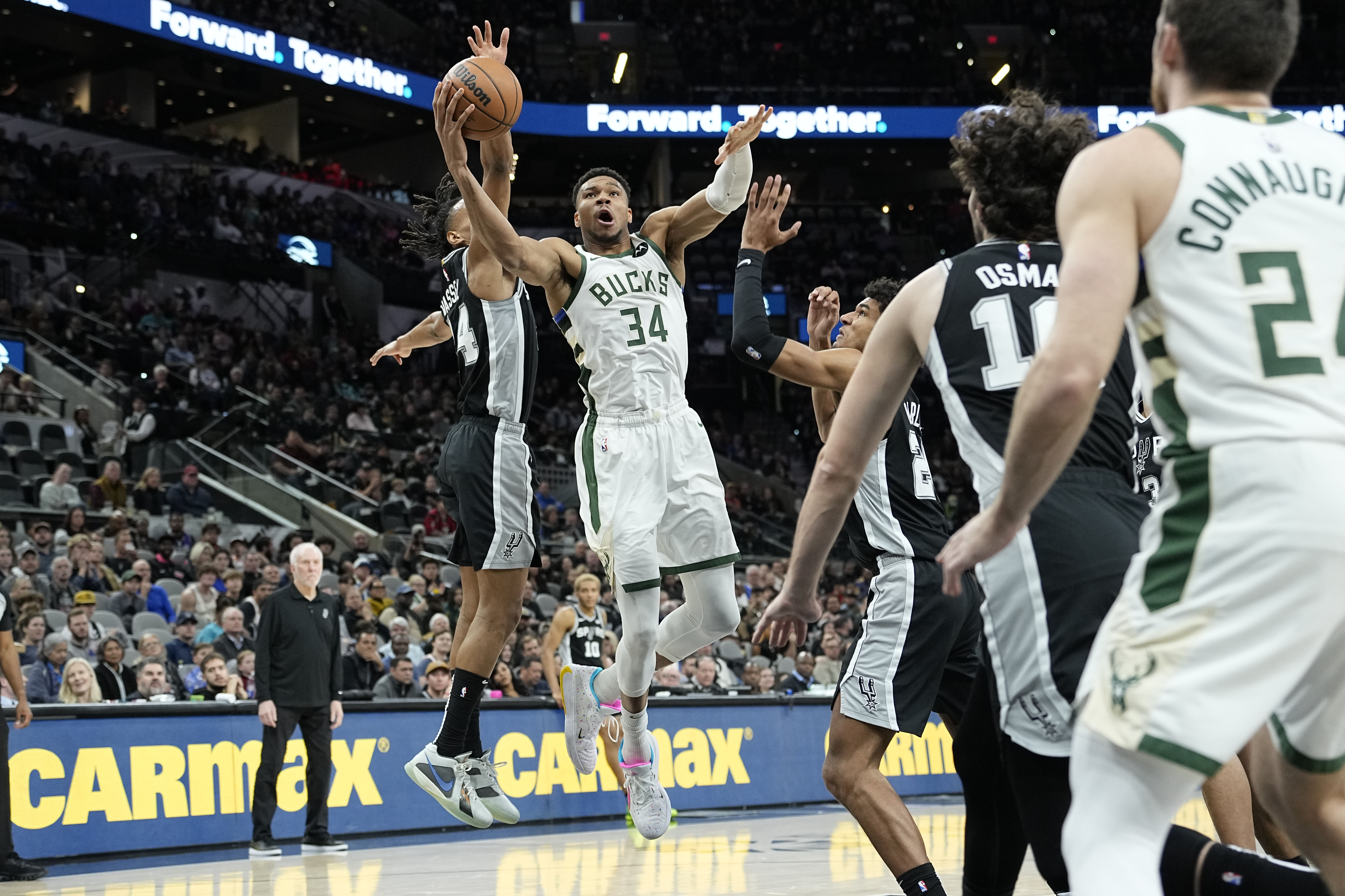 Jan 4, 2024; San Antonio, Texas, USA; Milwaukee Bucks forward Giannis Antetokounmpo (34) between San Antonio Spurs forward Dom Barlow (26) and guard Devin Vassell (24) during the first half at Frost Bank Center.
